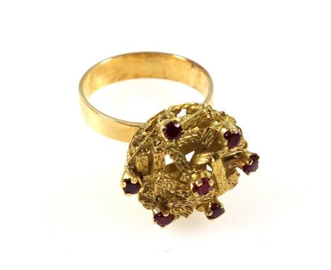 Yellow metal ring with 7 sapphires in a floral setting, stamped "750", 8.5grs, cased. (2) 
