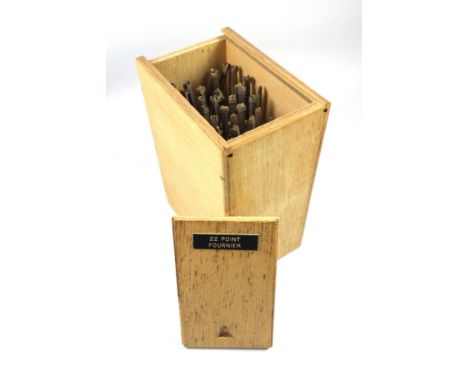 Wooden box containing 40 gold finishing hand tools comprising complete alphabet, numbers 0-9, ampersand, AE, OE, comma and po