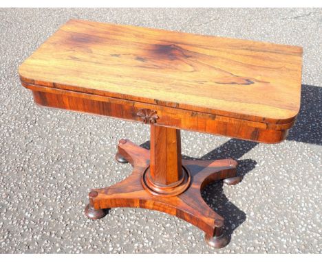 William IV rosewood card table, the folding rectangular top with 2 rounded corners, on a tapering octagonal column, quadripar