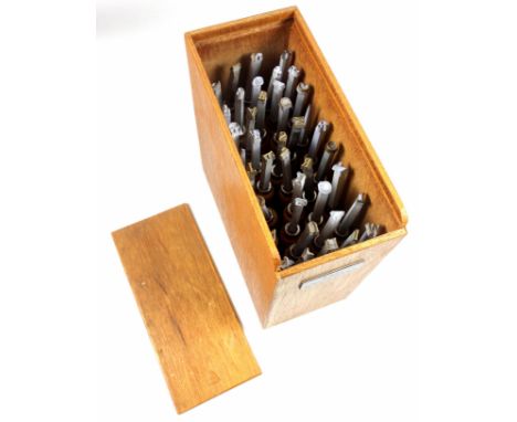 Wooden box containing 40 gold finishing hand tools comprising complete alphabet, numbers 1-9, ampersand, AE, OE, comma and po