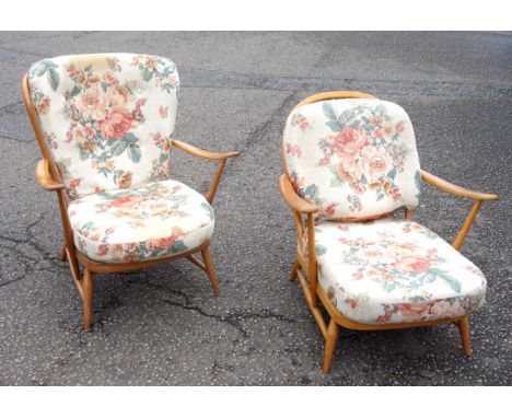 Two Ercol beech spindle back open armchairs of slightly differing sizes on turned tapering legs (one&nbsp;with steel rod stre