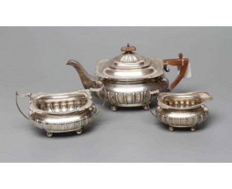 AN EDWARDIAN SILVER THREE PIECE TEA SERVICE, by James Deakin &amp; Sons, Sheffield 1910, of semi-fluted rounded oblong balust