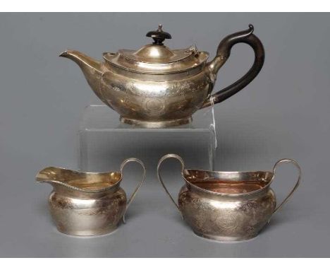 A BACHELOR'S EDWARDIAN SILVER THREE PIECE TEA SERVICE, by Nathan &amp; Hayes, Chester 1911 and 1912 (teapot), of oval baluste