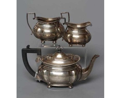 A LATE VICTORIAN THREE PIECE BACHELOR'S SILVER TEA SERVICE, by Nathan &amp; Hayes, Chester 1898, of lobed oblong form raised 