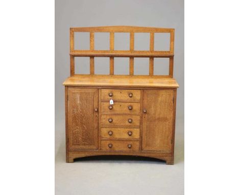 A SMALL HEALS STYLE ARTS AND CRAFTS SIDEBOARD, late 19th century, the mildly arched open panelled back with shallow shelf, th