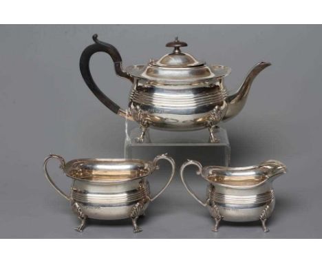 A THREE PIECE SILVER TEA SERVICE, by Jenkins &amp; Timms, Sheffield 1927, of rounded oblong baluster form with an applied eve