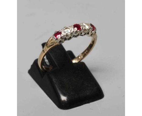 A RUBY AND DIAMOND RING, the three facet cut rubies and two round brilliant cut diamonds point set to a plain 9ct gold shank,