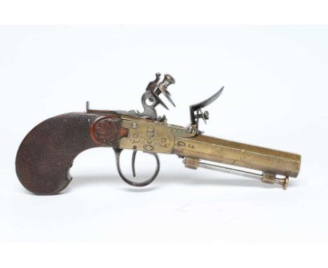 A BRASS FLINTLOCK TOP ACTION PISTOL with 3 1/2" octagonal barrel, manual slide safety, action etched with acorn and foliate d