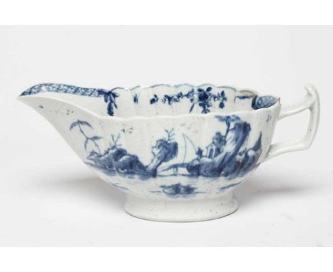 A WORCESTER PORCELAIN FRINGED TREE PATTERN SAUCEBOAT, c.1758, of fluted oval form and painted in underglaze blue, unmarked, 8