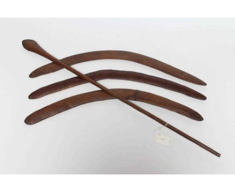ABORIGINAL TOOLS AND WEAPONS, c.1900, comprising three Boomerangs with linear carved patination, largest 26 7/8" long, and a 