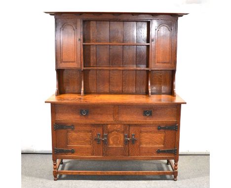 Arts &amp; Crafts oak dresser, designed by Ambrose Heal for Heal &amp; Son, dentil cornice, the panelled back with two fixed 