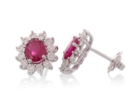 PAIR OF RUBY AND DIAMOND EARRINGS, set with oval rubies with diamond halos, in eighteen carat white gold