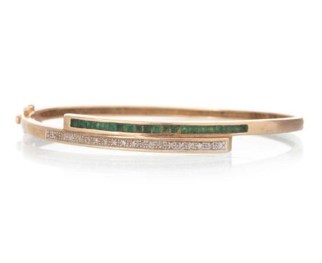 EMERALD AND DIAMOND BANGLE, set with a row of round brilliant cut diamonds and a row of princess cut emeralds, in nine carat 