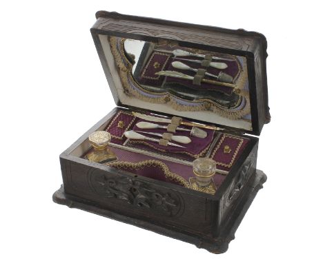 Black Forest carved treen sewing box, the hinged cover and sides with scrolling foliate carved cartouche enclosing an inset m