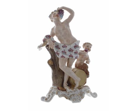 Sitzendorf porcelain figural group of Bacchus, modelled leaning against a tree trunk eating grapes, a faun by his side seated