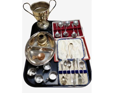 A collection of cutlery including pair of silver sugar tongs, silver-plated trophy cup on stand, etc.