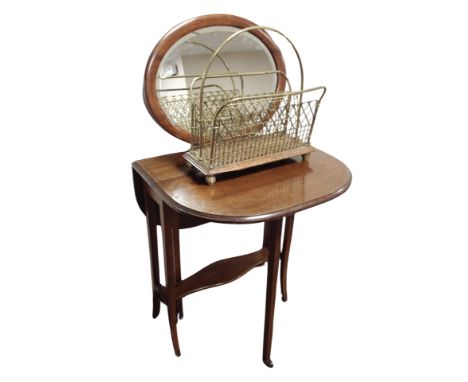 An Edwardian mahogany Sutherland table, oak and brass magazine rack and an oval mirror 