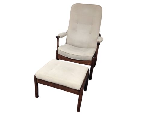 A 20th century stained beech armchair and matching footstool in button suede upholstery 