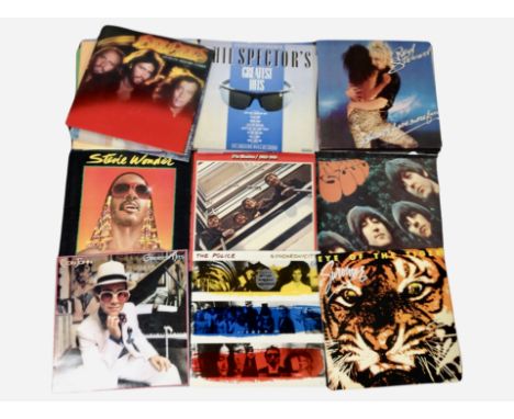 A group of vinyl LP records including the Beatles, Elton John, The Police, Stevie Wonder, Rod Stewart, Michael Jackson, ABBA,