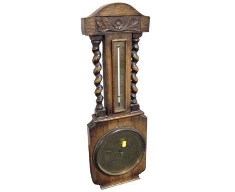A carved oak barometer, height 70 cm