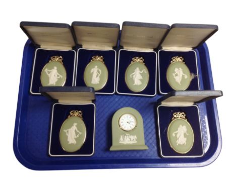 Six boxed Wedgwood green Jasperware cameos, and a similar mantel clock.