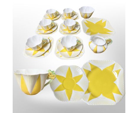 A scarce suite of Shelley tea china with yellow geometric flower head design and floral handles, comprising six tea cup, sauc