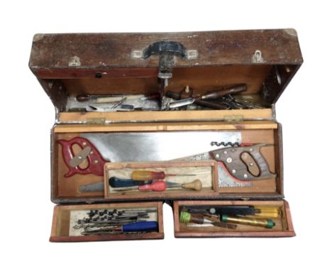 An antique joiner's tool box containing carpentry tools 