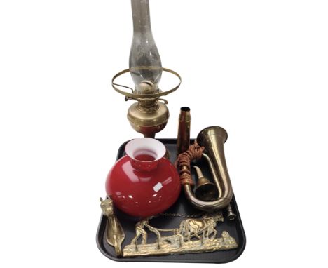 A brass oil lamp with red glass shade, together with a brass bugle, two coat racks, a large ammunition casing, etc.