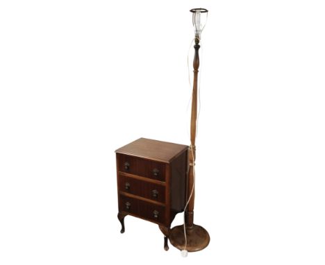 A mahogany three drawer low chest and a standard lamp 