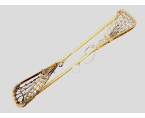 Two vintage Lacrosse sticks and a ball with various signatures 