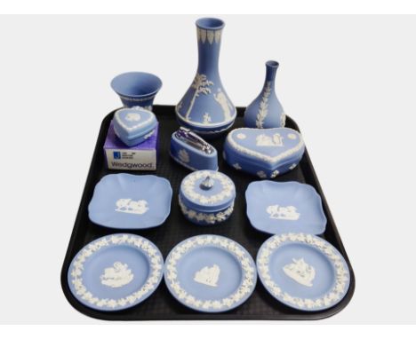 Twelve pieces of Wedgwood blue Jasperware including vases, heart-shaped trinket boxes, pin dishes, table lighter.