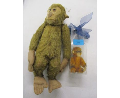 A Schuco monkey together with a wood wool stuffed monkey toy, possibly Steiff 