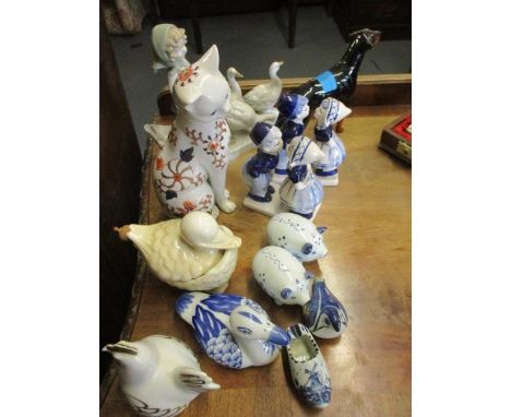 A Royal Worcester porcelain ornament of a chicken and other ornaments to include kissing Dutch children and a Beswick Doberma