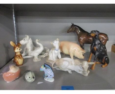 A Goebel figure of a pig, a Beswick figure of a horse, a Herend figure of an angel fish, Russian and Danish models of animals