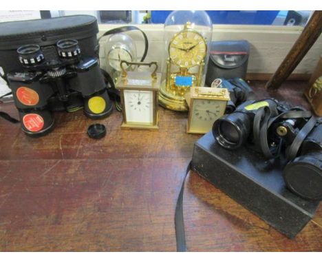 A selection of clocks and binoculars to include an Angelus carriage clock 