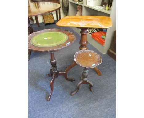 A late Georgian tripod table with vase shaped column, scrolled legs, 29" h and two others 