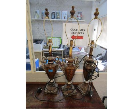 A group of three matching composition lamp bases with fittings 