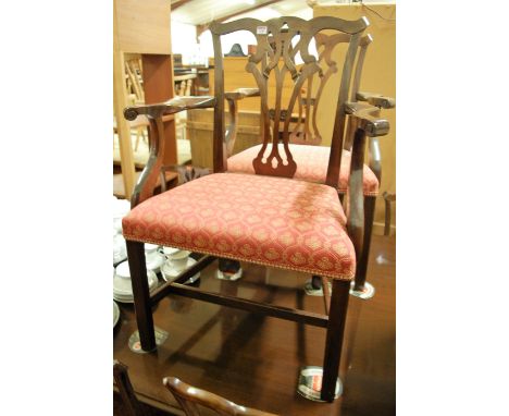 A set of ten Chippendale style mahogany splatback dining chairs, each having red floral upholstered stuffover seats (8+2)