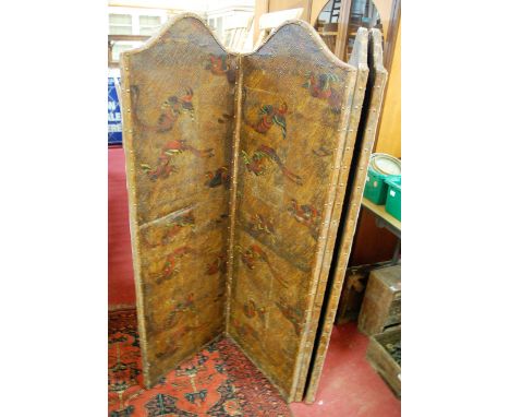 An early 20th century tan leather clad and brass studded four-fold dressing screen, each section with arched top and polychro