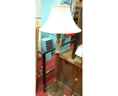 A contemporary silvered and gilt standard lamp with fluted column, with cream shade