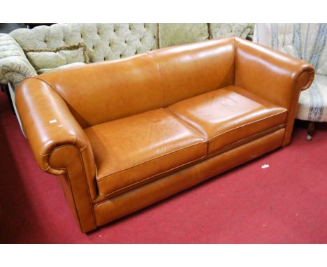 A contemporary tan leather three-seater sofa, having rolled arms, w.188cm