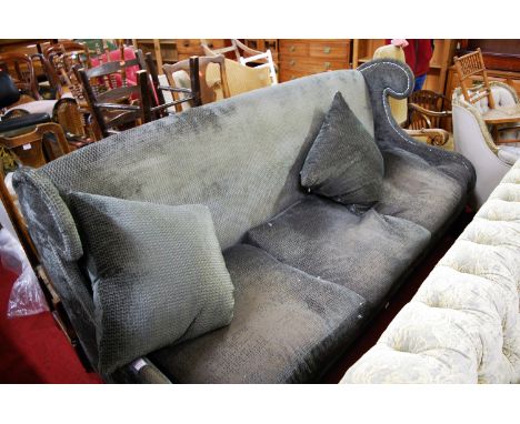 A contemporary upholstered and studded four seater wingback sofa raised on tapering supports, width 220cm