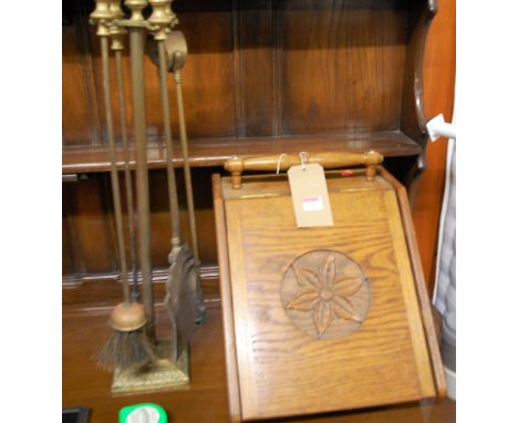 An early 20th century oak coal purdonium; together with a brass fire tools set on stand (2)