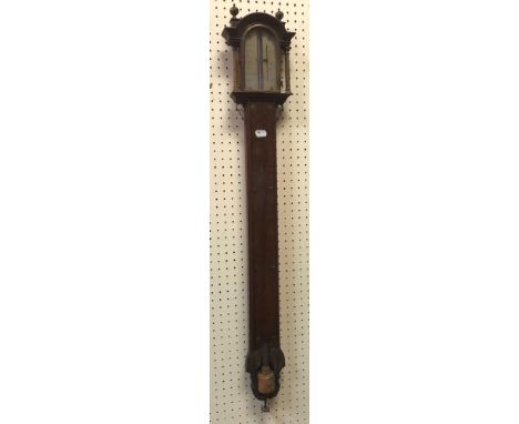 A 19th Century mahogany cased stick barometer, the domed top over a silvered dial with glazed door front flanked by two taper