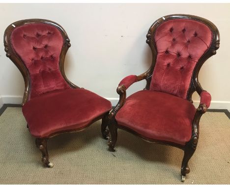 A pair of Victorian ladies and gents walnut framed salon chairs with button backs on cabriole front legs to scroll feet and c