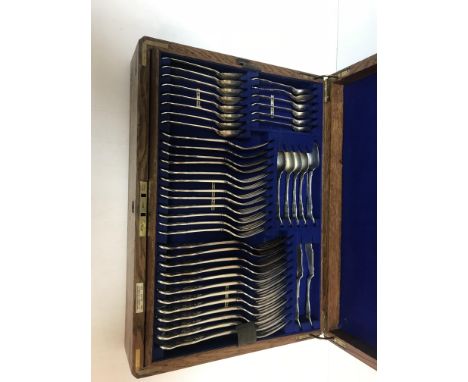 An Edwardian oak canteen of silver kings pattern cutlery comprising eight table forks, eight dessert forks, eight table spoon