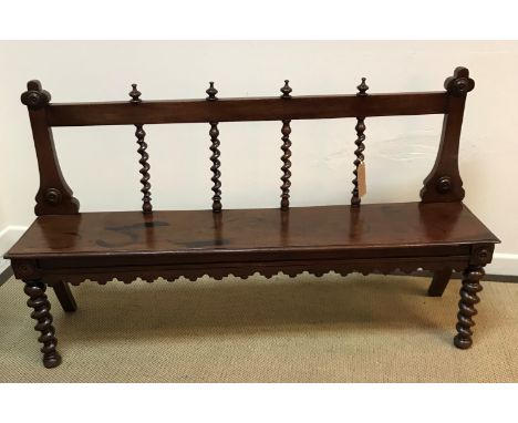 A Victorian mahogany hall bench, the barley twist railed back over a single piece seat with moulded edge raised on barley twi