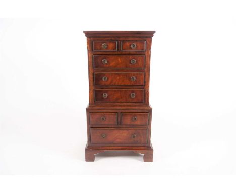 A George III style mahogany, miniature chest on chest, the upper section with two short over three long drawers and the base 