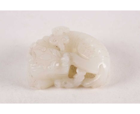 A Chinese carved white jade figure of a recumbent bixie with a stem lingzhi in its mouth. 76.6 grams. 5 cm long x 3.6 wide x 