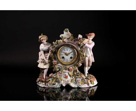 A late 19th century Sitzendorf porcelain figural mantel clock, with floral encrustations, an eight day Lenzkirch movement, ch